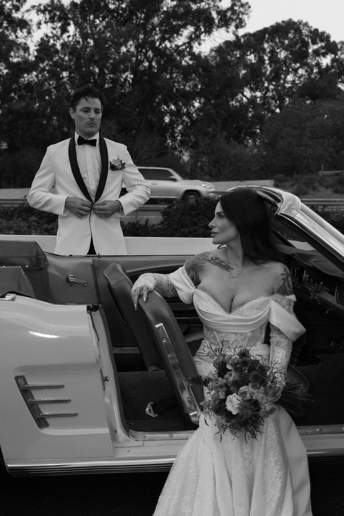 Bride and groom with a vintage convertible